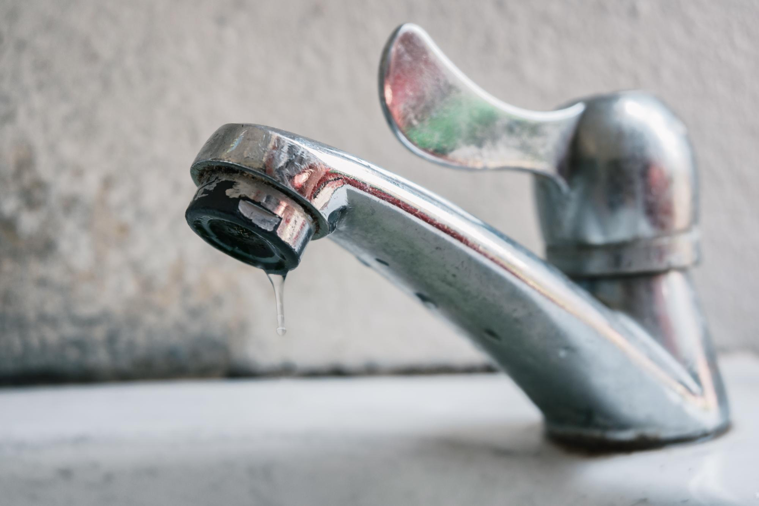 Plumber repairing water leak - Tips for saving money on water bills